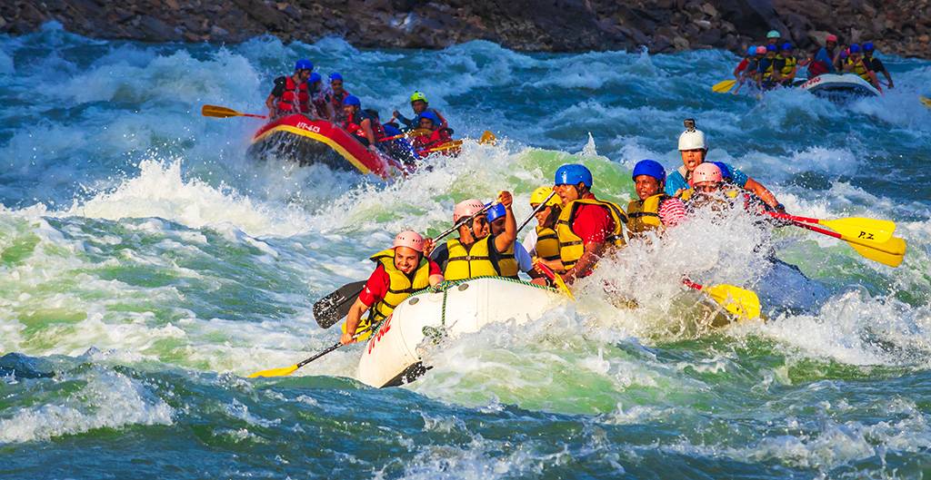 People doing rafting in some rapids.